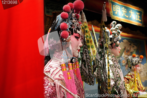 Image of chinese opera dummy and red cloth as text space ,it is a toy,not