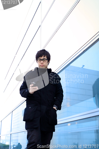 Image of Business man using cellphone when waiting in station. 