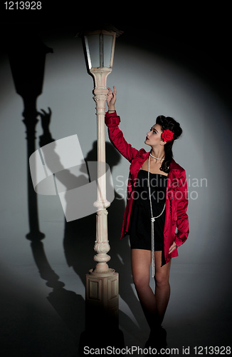 Image of young woman and lightpole