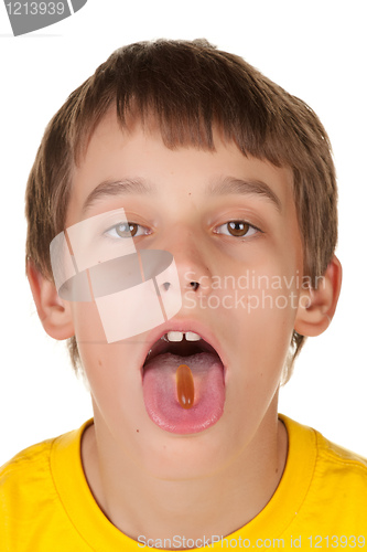 Image of boy taking a pill