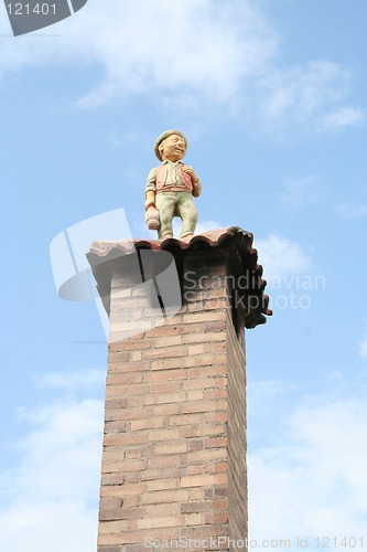 Image of Man standing on  chimney