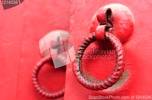 Image of Red door with iron doorknobs