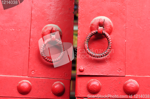 Image of Red door with iron doorknobs