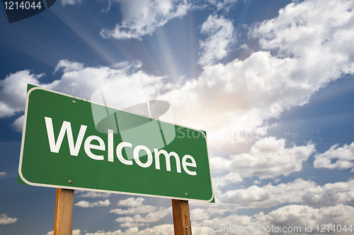 Image of Welcome Green Road Sign Against Clouds