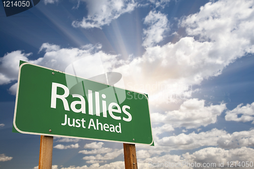 Image of Rallies Green Road Sign Against Clouds