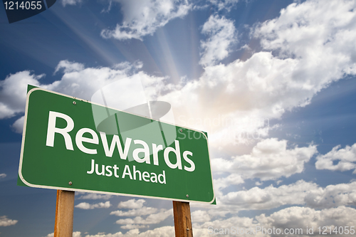 Image of Rewards Green Road Sign Against Clouds