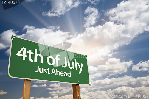 Image of 4th of July Green Road Sign Against Clouds