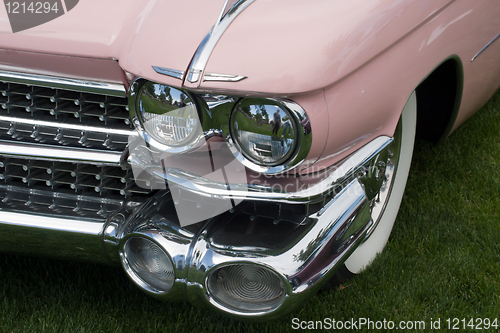 Image of Front side of a pink classic car