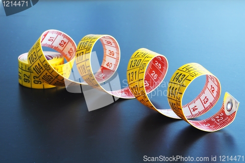 Image of measuring tape on blue background
