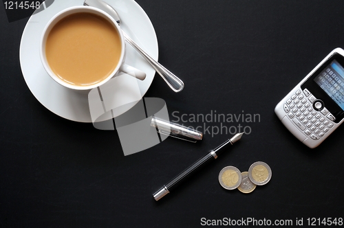 Image of coffee pen phone and paper