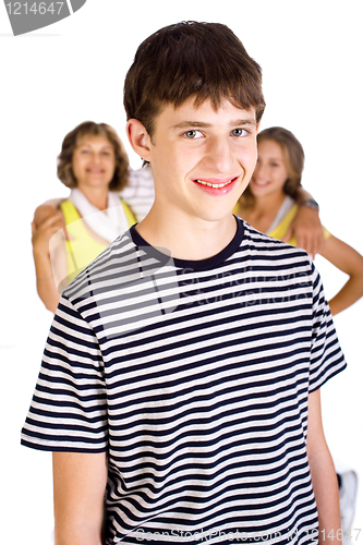 Image of Smiling young kid in focus with family in the background