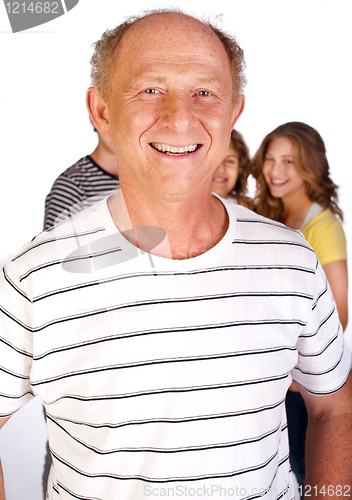 Image of Handsome old man in focus with family in the background