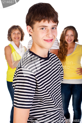 Image of Smiling young kid in focus with family in the background