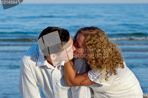 Image of Young couple are kissing.