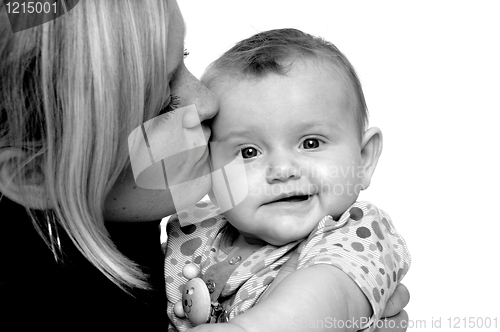 Image of Mother is kissing baby