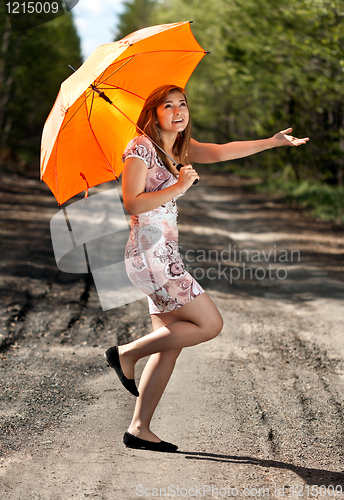 Image of beautiful girl with an orange umbrella