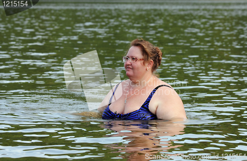 Image of plump woman bath in river