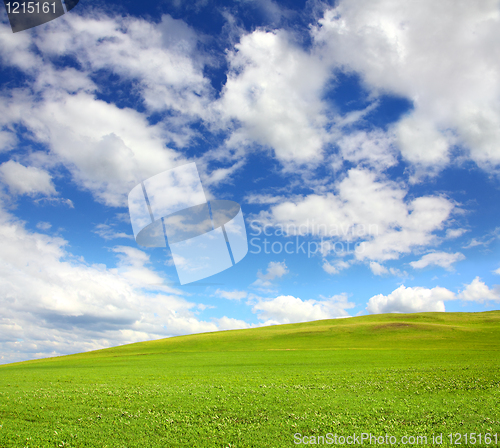 Image of green hill with grass under sky