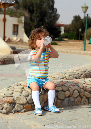 Image of little girl drinking from bottle