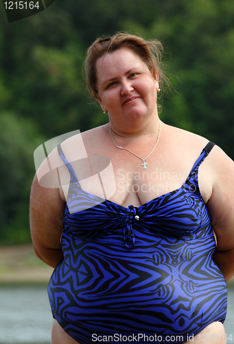 Image of plump woman standing near river