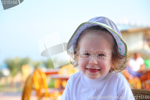 Image of laughing little girl in hat