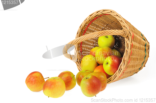 Image of Fresh apples spilling out of basket - isolated on white background. Clipping path included.