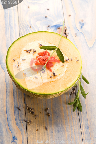 Image of fresh melon soup with parma ham and lavender flower