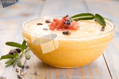 Image of fresh melon soup with parma ham and lavender flower