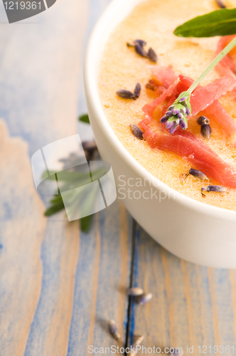 Image of fresh melon soup with parma ham and lavender flower