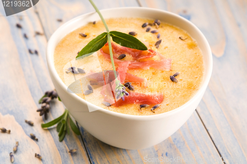Image of fresh melon soup with parma ham and lavender flower