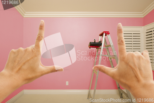 Image of Hands Framing Pink Painted Wall Interior