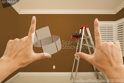 Image of Hands Framing Brown Painted Wall Interior