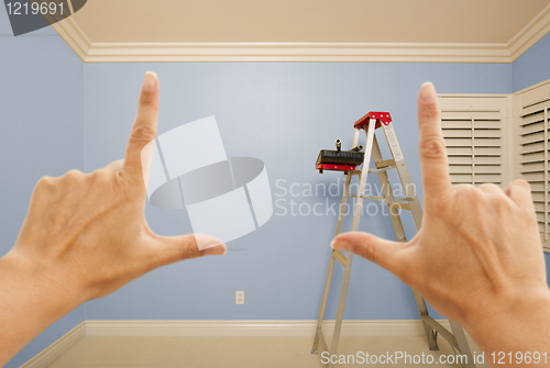 Image of Hands Framing Blue Painted Wall Interior