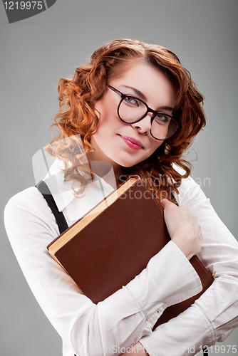 Image of young woman in glasses with a book