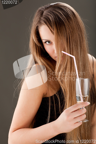 Image of young woman with bocal of wine