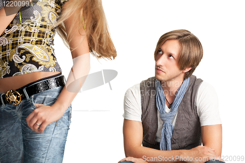 Image of sittng men looks at woman bottom