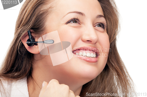 Image of young beautiful business woman with headsetling
