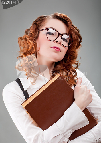 Image of young woman in glasses with a book