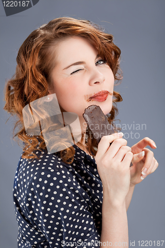 Image of happy smiling woman eating chocolate