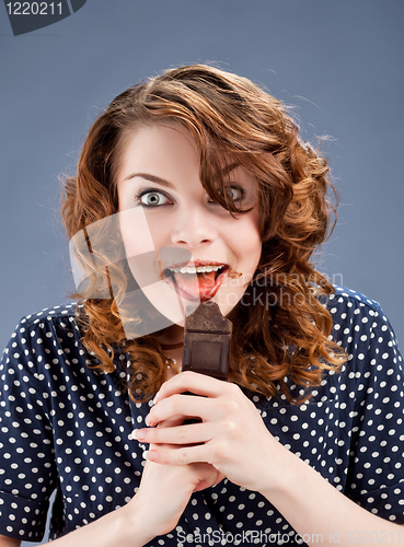 Image of happy smiling woman eating chocolate