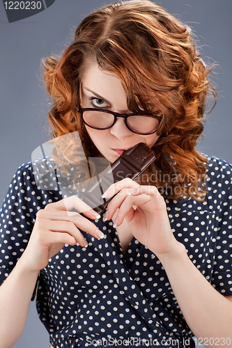 Image of happy smiling woman eating chocolate