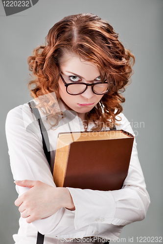 Image of young woman in glasses with a book