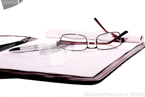 Image of sunglasses and pen place on note book isolate on white background 