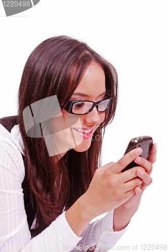 Image of Beutiful happy woman sending text at mobile phone