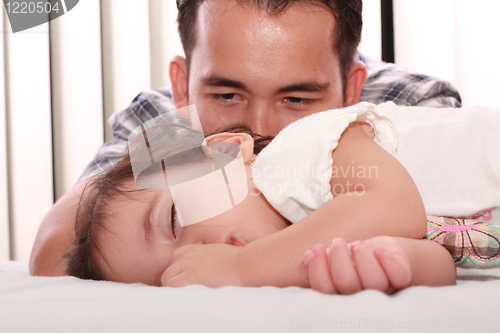 Image of Father watch his beautiful baby while she sleeps