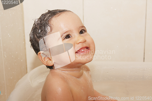 Image of litlle baby bathes in a bathroom