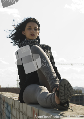 Image of Young woman on roof