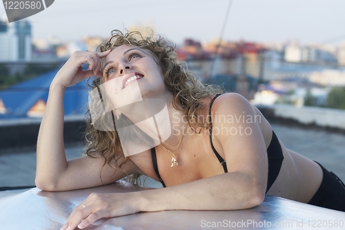 Image of Young woman on roof