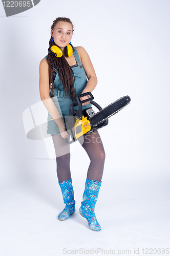 Image of Pretty girl with chainsaw