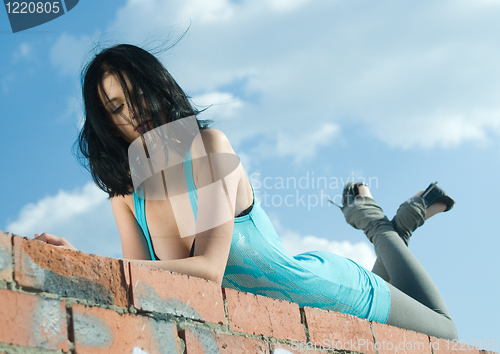 Image of Young woman on roof